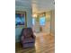 View of a dining room with a small table and a purple chair in the foreground at 201 Jacaranda Dr, Leesburg, FL 34748