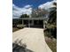 Well-maintained exterior with a driveway, lush lawn, and mature landscaping at 201 Jacaranda Dr, Leesburg, FL 34748