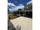 Well-maintained exterior with a driveway, lush lawn, and mature landscaping at 201 Jacaranda Dr, Leesburg, FL 34748