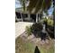 Charming front yard featuring lush landscaping, with mature trees and a manicured lawn at 201 Jacaranda Dr, Leesburg, FL 34748