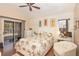 Bedroom with a vaulted ceiling, light walls, wood floors, and a sliding glass door at 202 N Palm Ave, Howey In The Hills, FL 34737