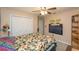 Comfortable bedroom with ceiling fan, double closet, and a wall-mounted TV at 202 N Palm Ave, Howey In The Hills, FL 34737