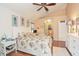 Bedroom with light neutral walls, vaulted ceiling, light wood floors, white furniture, and a queen bed at 202 N Palm Ave, Howey In The Hills, FL 34737