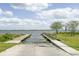 View of a boat ramp providing access to the lake, backed by a blue sky at 202 N Palm Ave, Howey In The Hills, FL 34737