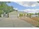 Charming single-story home with a well-manicured front yard and attached two-car garage at 202 N Palm Ave, Howey In The Hills, FL 34737