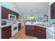 Bright kitchen with modern appliances, dark cabinets, and breakfast bar at 202 N Palm Ave, Howey In The Hills, FL 34737