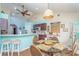 Eat in kitchen area with a ceiling fan, breakfast bar, modern appliances and seating at 202 N Palm Ave, Howey In The Hills, FL 34737