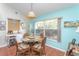 Kitchen area featuring a dining table, glass window with natural light, and decor accents at 202 N Palm Ave, Howey In The Hills, FL 34737
