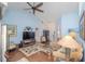 Bright and cozy living room featuring vaulted ceilings, laminate flooring, and ample natural light at 202 N Palm Ave, Howey In The Hills, FL 34737