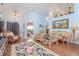Cozy living room featuring laminate flooring, an open layout, and views into the kitchen and dining areas at 202 N Palm Ave, Howey In The Hills, FL 34737