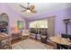 Comfortable living room with a ceiling fan, large window and an area rug at 202 N Palm Ave, Howey In The Hills, FL 34737
