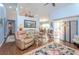 Bright and airy living room featuring high ceilings, laminate flooring, and an open layout at 202 N Palm Ave, Howey In The Hills, FL 34737