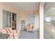 Enclosed patio with neutral colored walls, a ceiling fan, and striped furniture at 202 N Palm Ave, Howey In The Hills, FL 34737