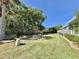 Wide backyard view with lush green grass, trees, and manicured garden beds, offering a serene outdoor space at 207 Hawthorne Blvd, Leesburg, FL 34748