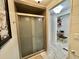 Shower with sliding glass doors and an adjacent dressing table at 207 Hawthorne Blvd, Leesburg, FL 34748
