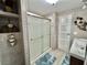 Bathroom featuring wood plank walls, a glass enclosed shower, and decorative touches at 207 Hawthorne Blvd, Leesburg, FL 34748