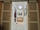 Bathroom with a sink, cabinets, and a view through sliding doors to a walk-in closet at 207 Hawthorne Blvd, Leesburg, FL 34748