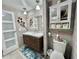 Bathroom featuring wood plank walls, a sink with wooden cabinets, and a toilet at 207 Hawthorne Blvd, Leesburg, FL 34748