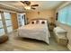Bedroom with a large bed, bedside tables, and a ceiling fan at 207 Hawthorne Blvd, Leesburg, FL 34748