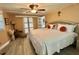 Bedroom featuring a decorative ceiling fan, a king bed and ensuite bathroom at 207 Hawthorne Blvd, Leesburg, FL 34748