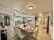 Open-concept dining room flows seamlessly into the living room and features a modern marble table at 207 Hawthorne Blvd, Leesburg, FL 34748