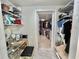 Dressing area between a closet and walk-in closet with shelves, a makeup table, a stool, and bright lighting at 207 Hawthorne Blvd, Leesburg, FL 34748