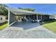 Charming single-story home featuring a covered parking area and inviting front porch at 207 Hawthorne Blvd, Leesburg, FL 34748