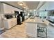 Updated kitchen with stainless steel appliances, breakfast bar, and seamless flow to the living area at 207 Hawthorne Blvd, Leesburg, FL 34748
