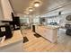 Open kitchen with a breakfast bar overlooks the dining and living areas, creating an inviting space at 207 Hawthorne Blvd, Leesburg, FL 34748