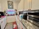 Efficient kitchen with white cabinets, granite countertops, and ample storage space at 207 Hawthorne Blvd, Leesburg, FL 34748