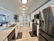 Updated kitchen featuring stainless steel appliances, white cabinets, and a center island with counter seating at 207 Hawthorne Blvd, Leesburg, FL 34748