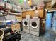 Laundry room includes washer, dryer, storage, and folding area for convenience at 207 Hawthorne Blvd, Leesburg, FL 34748