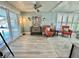Bright living area with stylish furnishings, including armchairs and light-colored flooring at 207 Hawthorne Blvd, Leesburg, FL 34748
