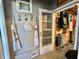 Mudroom with storage for aprons and hats, leading to the exterior and laundry at 207 Hawthorne Blvd, Leesburg, FL 34748