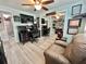 Office featuring built-in desk, shelving, and a leather chair; and wood-look flooring at 207 Hawthorne Blvd, Leesburg, FL 34748