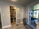 Pantry with sliding door and ample storage, in a home with wood look floors at 207 Hawthorne Blvd, Leesburg, FL 34748