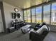 Cozy sunroom with a TV, sitting area with comfortable chairs, and natural light streaming through the windows at 207 Hawthorne Blvd, Leesburg, FL 34748