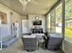 Relaxing sunroom with mounted TV and comfortable seating for entertainment at 207 Hawthorne Blvd, Leesburg, FL 34748
