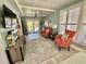 Bright sunroom featuring cozy seating, stylish rug, and abundant natural light from large windows at 207 Hawthorne Blvd, Leesburg, FL 34748