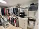 Bright walk-in closet with clothing racks and shelves, featuring a built-in safe and chest of drawers at 207 Hawthorne Blvd, Leesburg, FL 34748