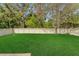 Large backyard with a white picket fence, offering a private and serene outdoor space at 20816 Sullivan Ranch Blvd, Mount Dora, FL 32757