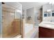 Bathroom features a double vanity, soaking tub and glass enclosed shower with tile surround at 20816 Sullivan Ranch Blvd, Mount Dora, FL 32757