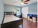 Bedroom featuring hardwood floors, closet, and desk with a window at 20816 Sullivan Ranch Blvd, Mount Dora, FL 32757