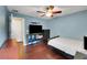 Bedroom features wood floors and a ceiling fan at 20816 Sullivan Ranch Blvd, Mount Dora, FL 32757