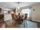 Cozy dining room with seating for four, next to the kitchen with stainless appliances at 20816 Sullivan Ranch Blvd, Mount Dora, FL 32757