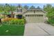 Charming home featuring a two-car garage, lush landscaping, and a well-maintained lawn at 20816 Sullivan Ranch Blvd, Mount Dora, FL 32757