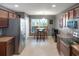 Bright kitchen with stainless steel appliances, a dining table and dark wooden cabinets at 20816 Sullivan Ranch Blvd, Mount Dora, FL 32757