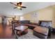 Spacious living room features a large sectional sofa and modern ceiling fan at 20816 Sullivan Ranch Blvd, Mount Dora, FL 32757