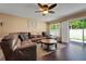 Spacious living room features a large sectional sofa and modern ceiling fan at 20816 Sullivan Ranch Blvd, Mount Dora, FL 32757