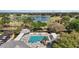 Aerial view of a community pool, lake, and golf course at 2142 Margarita Dr, The Villages, FL 32159